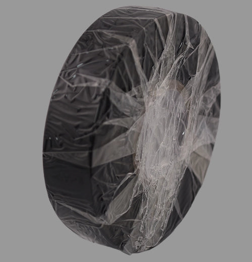 Non-adhesive black PVC tape standing on its end.