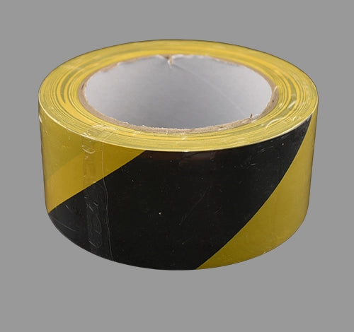 Black and yellow hazard tape laying flat.