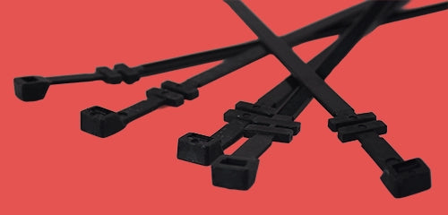 Group of cable tray fixing ties showing integrated mounting heads and fixing points for secure cable tray installations