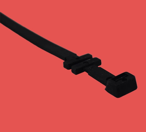 Cable tray fixing tie laying flat to show full length, head design, and fixing mechanism for tray attachment
