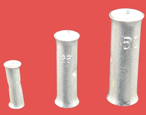 Copper tube butt connectors in three different sizes, standing upright on their ends.