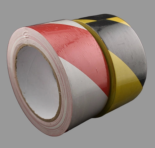Black and yellow and red and white hazard tapes side by side.