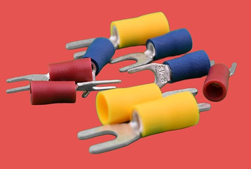 Assorted insulated fork terminals in red, blue, and yellow – vinyl crimp connectors for electrical wiring.