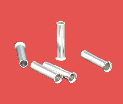 Close-up of uninsulated cord end terminals on red background