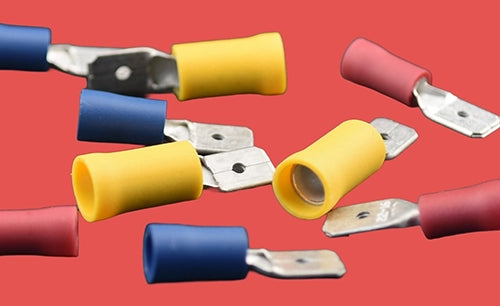 Assorted pre-insulated male spade connectors in red, blue, and yellow.