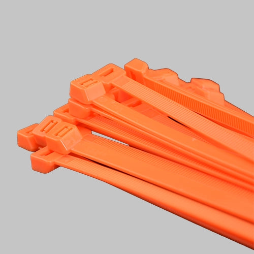 Neon orange cable ties bundle on grey background - fluorescent orange zip ties for construction and medical waste applications