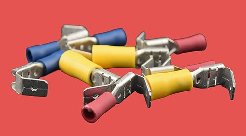 Assorted piggyback spade connectors with insulation in red, blue, and yellow.