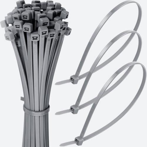 Bundle of grey cable ties with three zipped grey ties looped beside it on a white background.