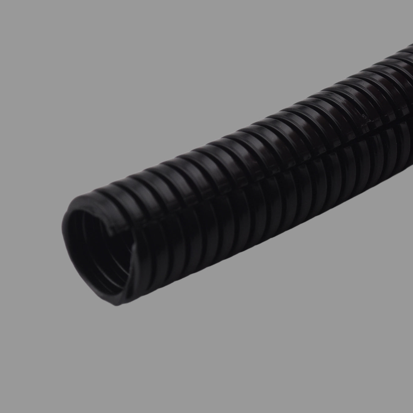 Black nylon split corrugated conduit showing open seam and ribbed structure