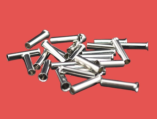 Loose pile of uninsulated bootlace ferrules for electrical trade use