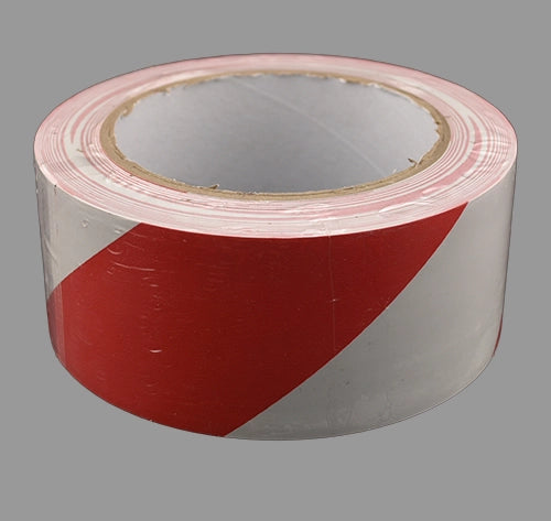 Red and white hazard tape laying flat.