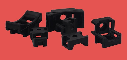 Group of black cable tie saddles in all three sizes – small, medium, and large