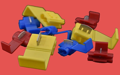 Assorted heat shrink in-line splice connectors in red, blue, and yellow.