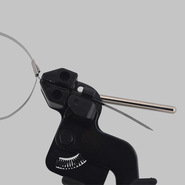 Black hand-held JCTCTTS-HD stainless steel cable tie tensioning gun pulling tight a silver stainless steel cable tie