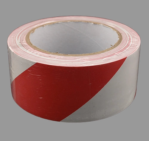 Red/white barrier tape laying flat.