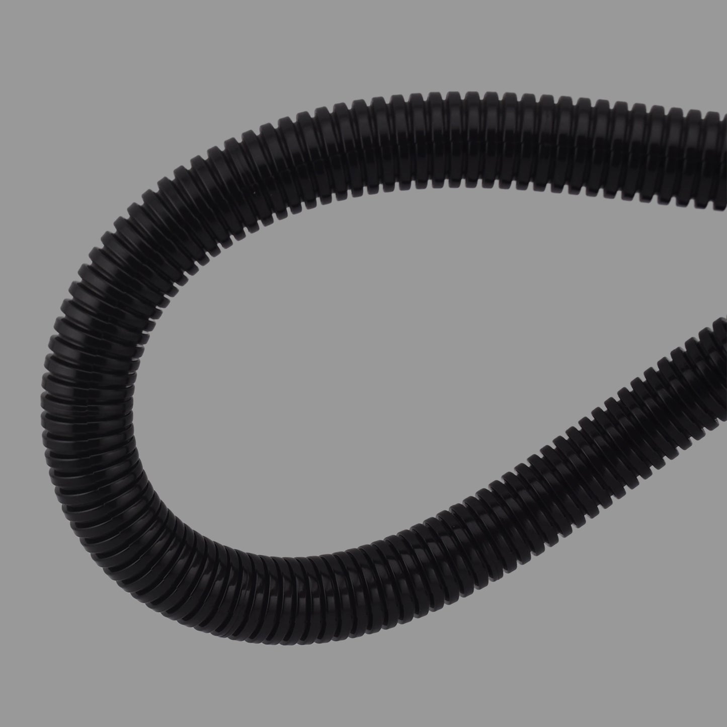 Flexible black nylon non-split conduit demonstrating high bend radius and durability