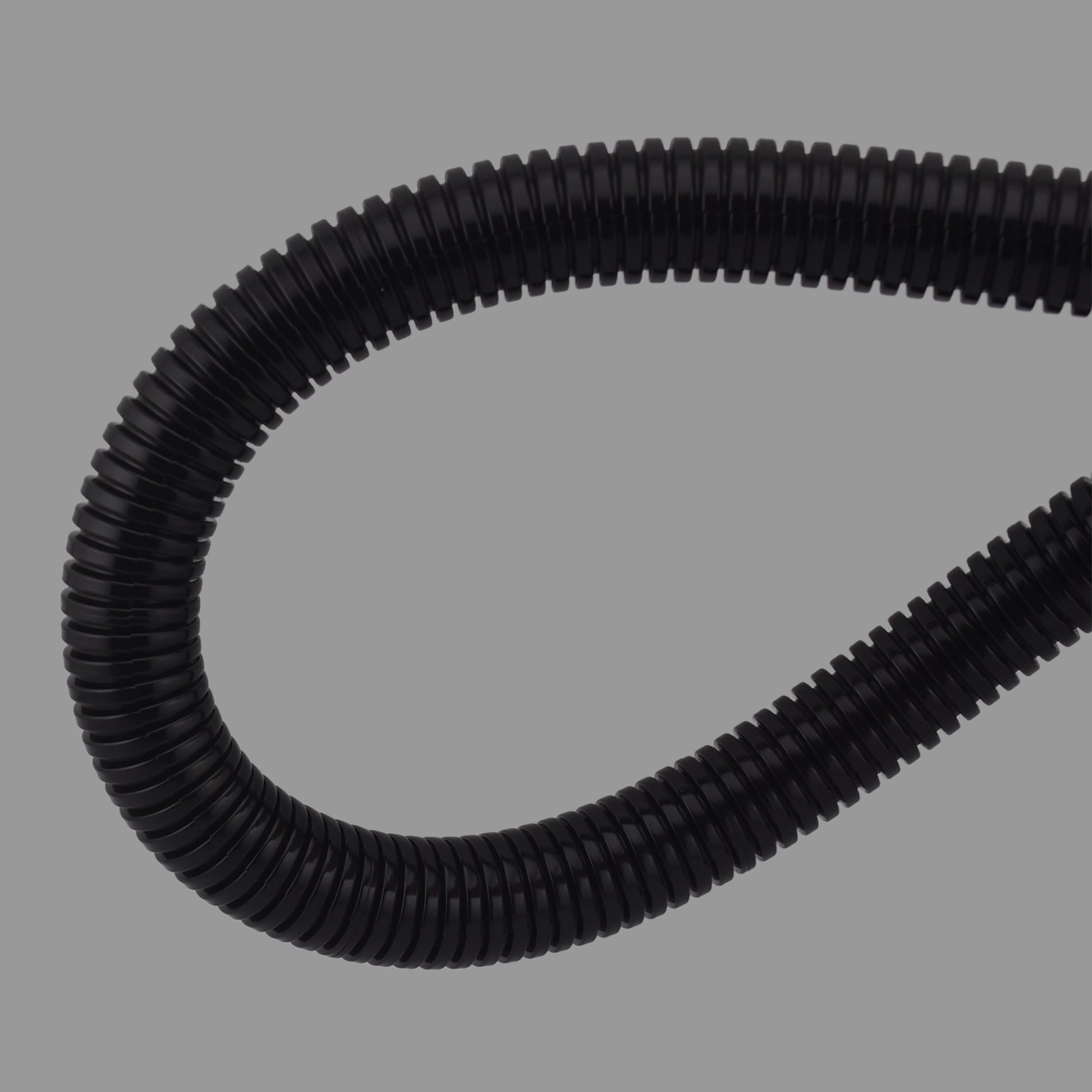 Flexible black nylon non-split conduit demonstrating high bend radius and durability
