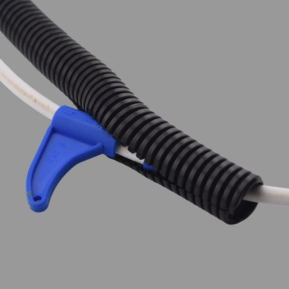Close-up of blue split conduit tool with HellermannTyton branding installing cable into nylon conduit