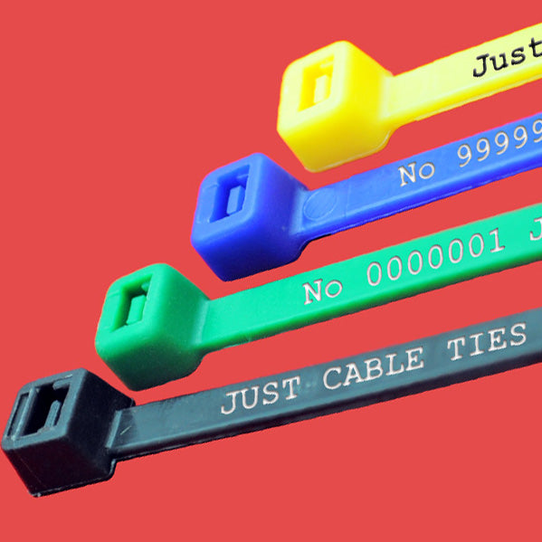 A selection of coloured, natural and black nylon cable ties with printed text and serial numbers printed on them and the locking head.