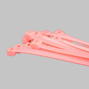 Neon pink cable ties bundle on grey background - fluorescent pink zip ties for event production and creative applications