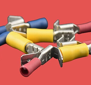 Assorted piggyback spade connectors with insulation in red, blue, and yellow.